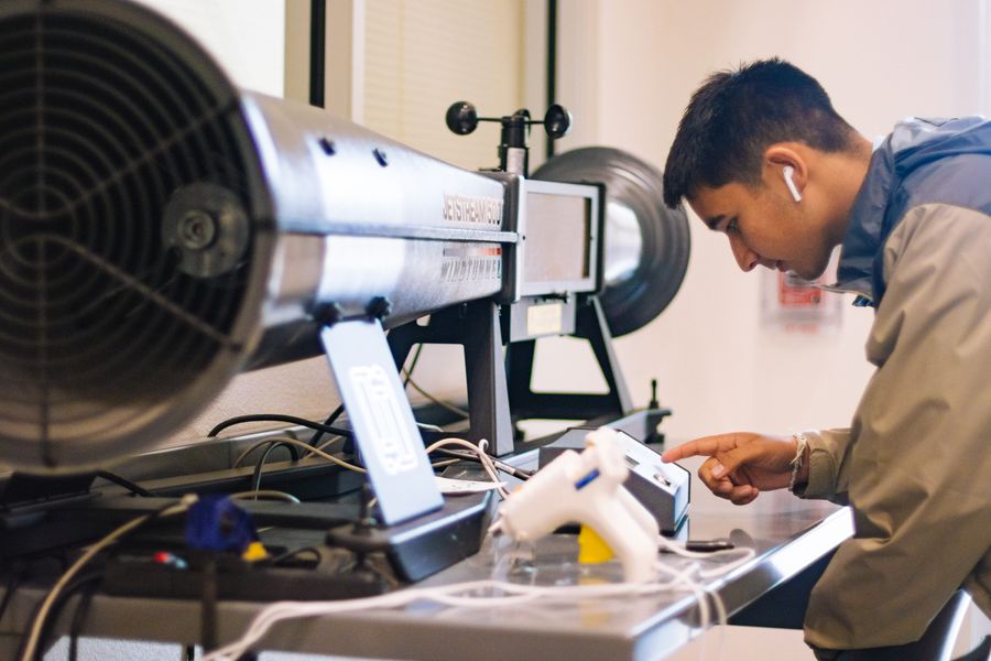 Engineering student working with lab hardware