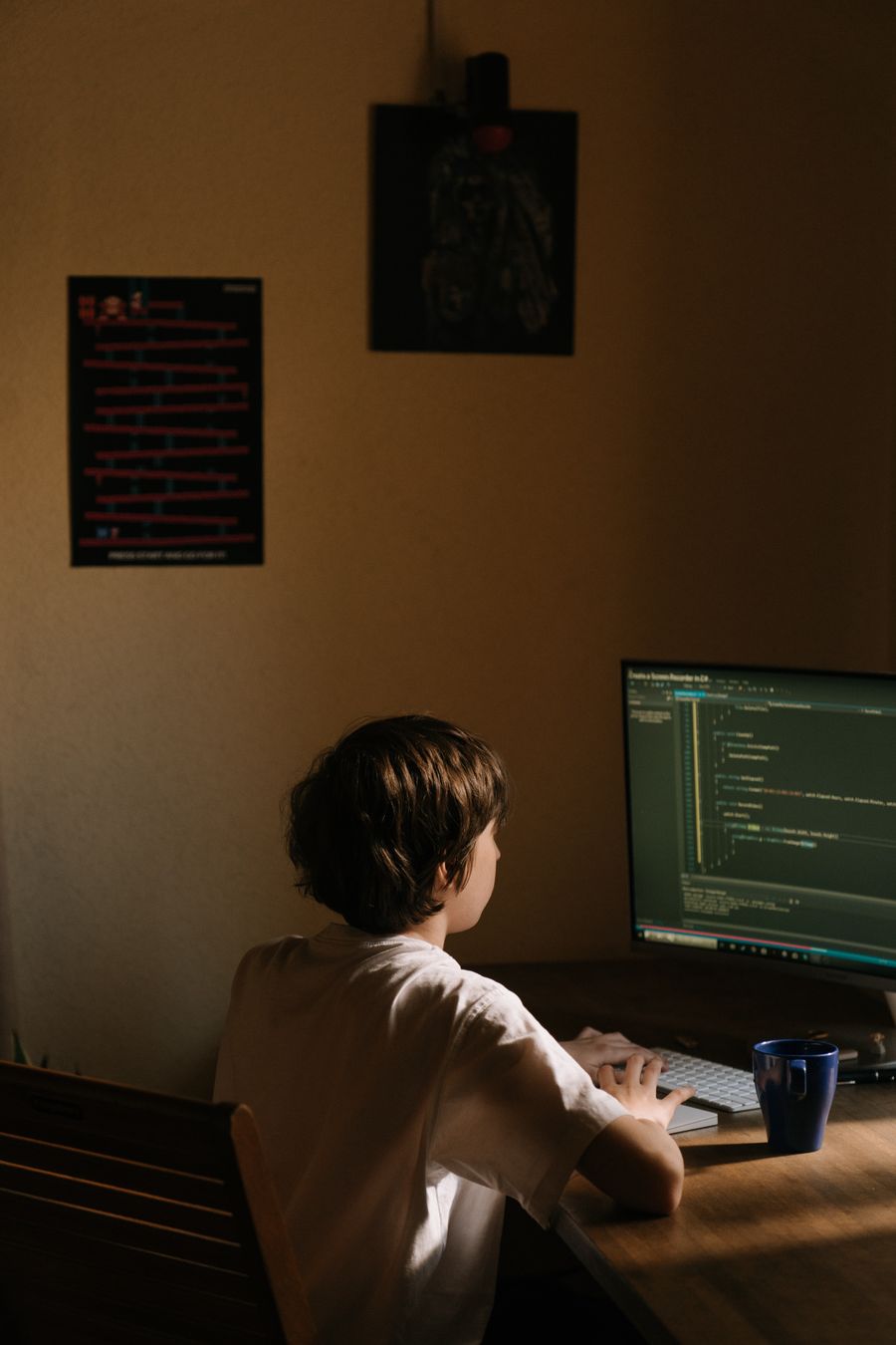 Programmer writing code at a desktop workstation